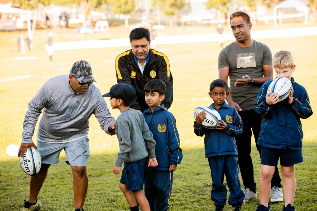 Pre School boys playing rugby with the dads