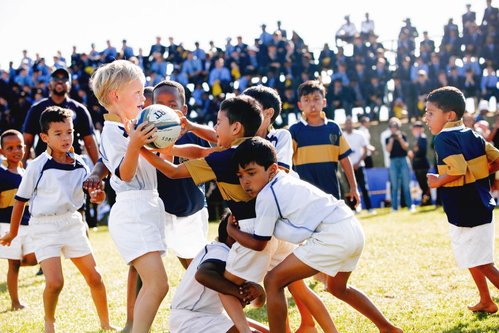 Junior Primary boys out on Old Orchards with the High School watching them play